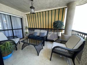 a balcony with chairs and a table and some windows at Sun, Sea, Beach Costa Calida Spain Henrys Apartment in Águilas