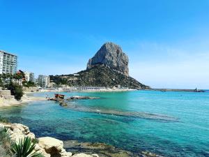 a view of a beach with a mountain in the background at GREEN LAGOON in Calpe