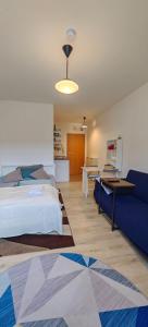 a bedroom with a bed and a blue couch at At Sarah´s (Fully Equiped Studio) in Trier