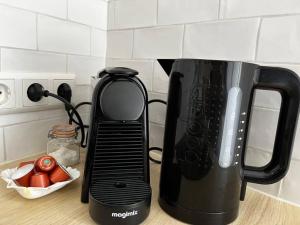 a black appliance sitting on top of a kitchen counter at Little Loft, Summerhouse near the beach in Noordwijk aan Zee