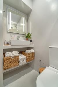 a bathroom with a sink and a mirror and towels at Arel luxury house in Kithnos +12 photos