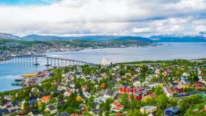 an aerial view of a city and a bridge over a body of water at City Home Aurora in Tromsø