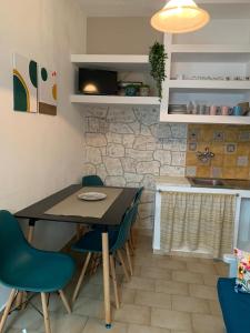 a dining room table and chairs in a kitchen at Kastro Studios in Skopelos Town