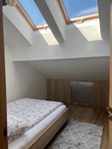 a bedroom with a bed and a skylight at Apartament Tarnów Klimeckiego 11 in Tarnów