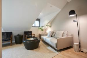a living room with a couch and a table at U-Sense Madrid Santa Ana in Madrid