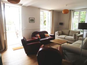a living room with a couch and a table at Les Coteaux in Montgeron