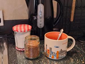 a cup of coffee sitting on a counter with spices at Peaceful retreat / spacious bedroom / free parking in Brighton & Hove