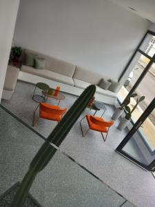 an overhead view of a living room with a couch and chairs at Bianco Hotel in Lakkíon