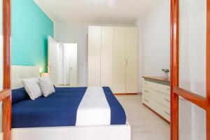 En eller flere senge i et værelse på Appartamento Turchese - MyHo Casa