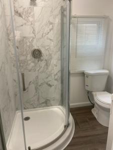 a bathroom with a shower and a toilet at 20 Dupont Beach House in Seaside Heights