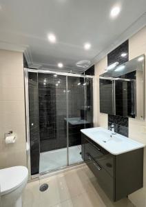 a bathroom with a shower and a sink and a toilet at Apartamento Praia Naval in Isla de Arosa