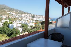 a balcony with a table and a view of a city at Amelia rooms in Batsi +15 photos