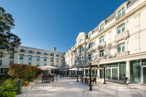 a large building with tables and chairs in front of it at Castilla Termal Solares in Solares