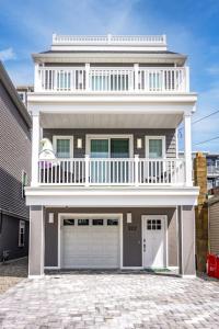 a large white house with a large garage at Cora's Beach Club in Seaside Heights