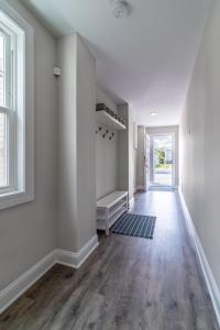 an empty hallway with white walls and wooden floors at Cora's Beach Club in Seaside Heights