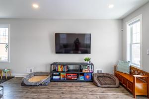 a living room with a flat screen tv on a wall at Cora's Beach Club in Seaside Heights