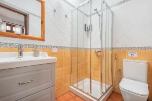 a bathroom with a shower and a toilet and a sink at Casa Hilaria in Garachico +24 photos