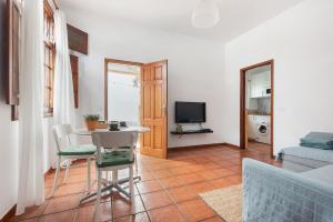 a living room with a table and a couch at Casa Hilaria in Garachico