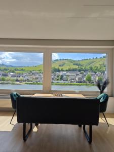 a living room with a pool table in front of a window at Ferienwohnung Schöne Aussicht in Zell an der Mosel