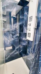 a bathroom with a shower with clouds painted on the wall at DUHOME apartment in the heart of Catania in Catania