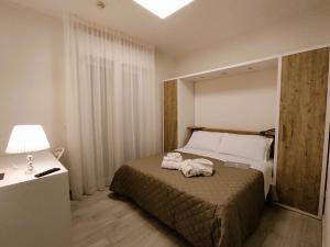 A bed or beds in a room at Hotel Gran San Bernardo - RICCIONE - FRONTE MARE CON CUCINA