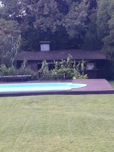 a frisbee laying on the grass in front of a house at Flor de Lis apartmento in Mar del Plata