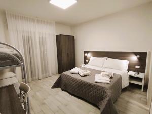 A bed or beds in a room at Hotel Gran San Bernardo - RICCIONE - FRONTE MARE CON CUCINA