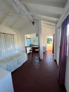a bedroom with a bed and a desk and a table at Flor de Lis apartmento in Mar del Plata