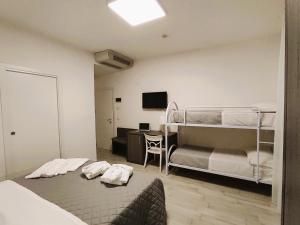 A bed or beds in a room at Hotel Gran San Bernardo - RICCIONE - FRONTE MARE CON CUCINA