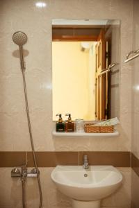 a bathroom with a toilet and a sink and a mirror at Thùy Trang Hotel in Vung Tau