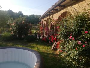 a backyard with a hot tub and some flowers at La casetta di samba in Anguillara Sabazia