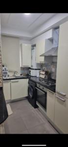 a kitchen with a stove and a dishwasher at Stylish City Apartment in Monastir