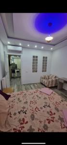 a large living room with a bed and a couch at Stylish City Apartment in Monastir