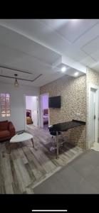 a living room with a ping pong table and a couch at Stylish City Apartment in Monastir