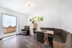 a living room with a table and a couch at Haus Tanja Apartment 3 in Parcines