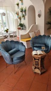 a living room with two chairs and a table at Casa Bon Bon in Positano