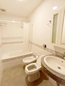 bagno bianco con servizi igienici e lavandino di Casa con Jardín y Parrilla a Federación