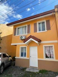 a house with a car parked in front of it at Full Aircon Camella House w/ wifi Netflix hotwater in Butuan