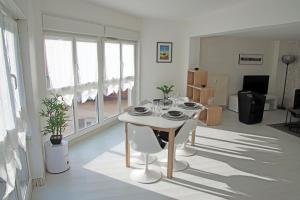 een woonkamer met een tafel en stoelen in een kamer bij GINA Epernay Hyper-Centre 2-4 P in Épernay