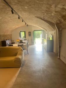 a living room with a yellow couch and a table at CAN MANYANA in Riudarenes