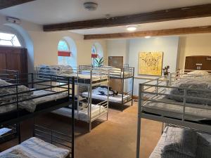 a room filled with lots of bunk beds at Llanfyllin Workhouse - Y Dolydd in Llanfyllin