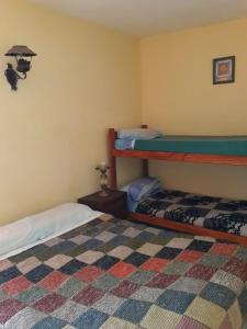 a bedroom with two bunk beds and a rug at Flor de Lis room #1 in Mar del Plata