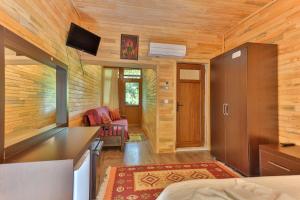 a room with a kitchen and a living room at Cinderella Pension & Bungalow in Cıralı