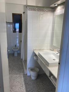 a bathroom with a sink and a toilet at Malvarrosa Beach Rooms in Valencia