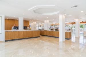 a lobby of a hospital with a reception counter at Globales Isabel in Cala Bona