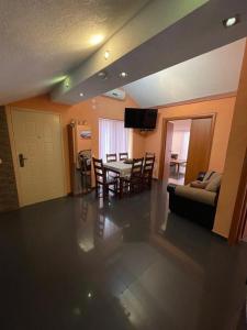 a living room with a table and a couch at Apartment Crocus of Rafailovici in Budva