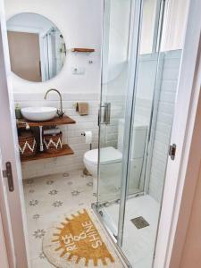 a bathroom with a glass shower and a toilet at Apartamento Boutique en la Playa in La Pineda +13 photos