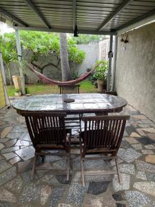 a table and two chairs on a patio at Bungalow Les Coraux in La Saline les Bains