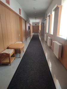 a hallway of a hospital with a long black carpet at Park Hotel in Nagyatád