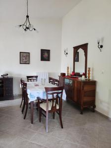 a dining room with a table and chairs and a mirror at EverGreen in Kavala